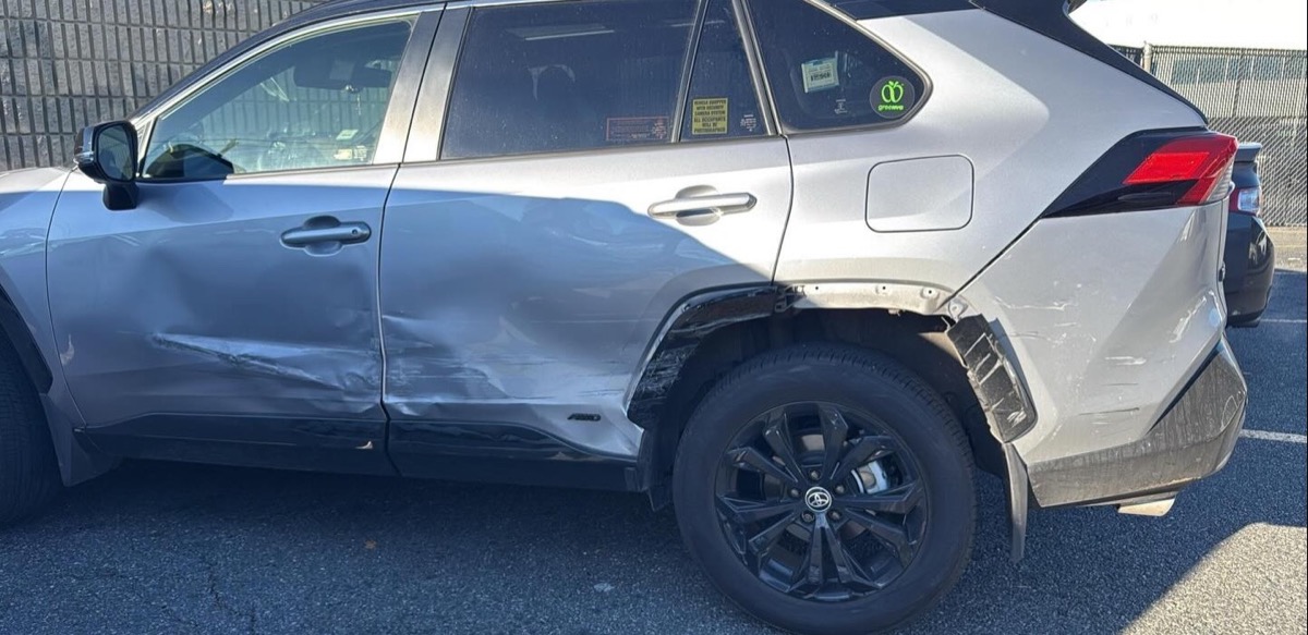Before: Toyota RAV4 with deep dents along both doors and the rear quarter